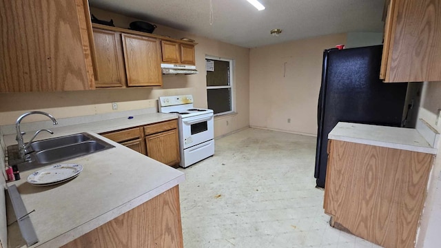 kitchen featuring electric range, light floors, light countertops, under cabinet range hood, and a sink