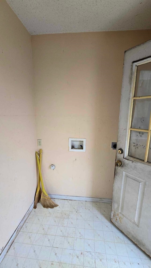 laundry room featuring laundry area, baseboards, washer hookup, and light floors