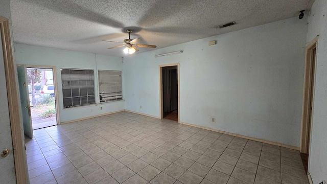 unfurnished room with baseboards, a textured ceiling, visible vents, and a ceiling fan