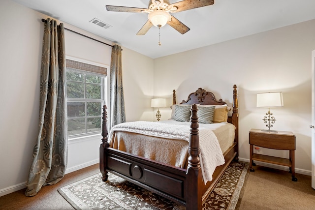 carpeted bedroom with ceiling fan, visible vents, and baseboards