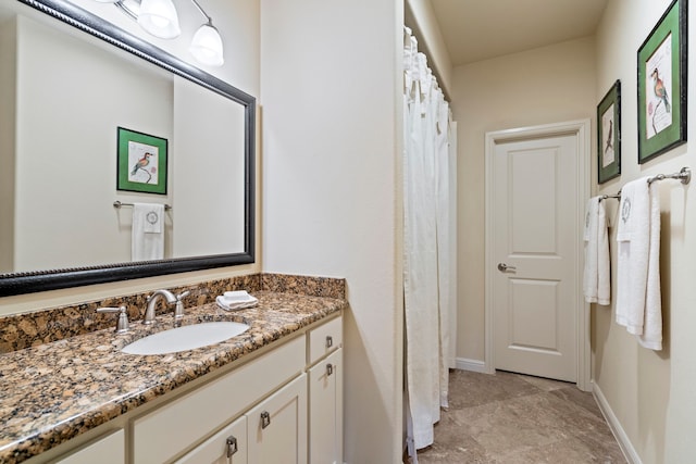 bathroom featuring baseboards and vanity