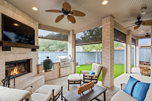 view of patio featuring ceiling fan, an outdoor brick fireplace, grilling area, and a fenced backyard