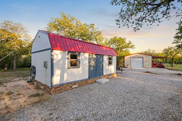 1036 Ten Box Rd, Sunset, TX 76270 - garage at dusk with a detached garage and driveway