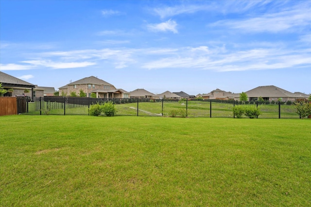 view of yard with fence and a residential view