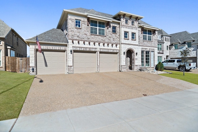 view of front of house with a shingled roof, concrete driveway, fence, a front lawn, and brick siding