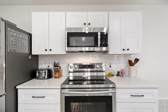 kitchen with white cabinets, stainless steel appliances, and light countertops