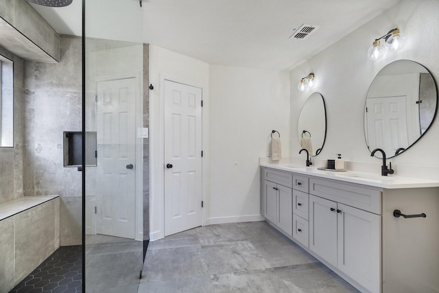 full bathroom with a walk in shower, double vanity, a sink, and visible vents