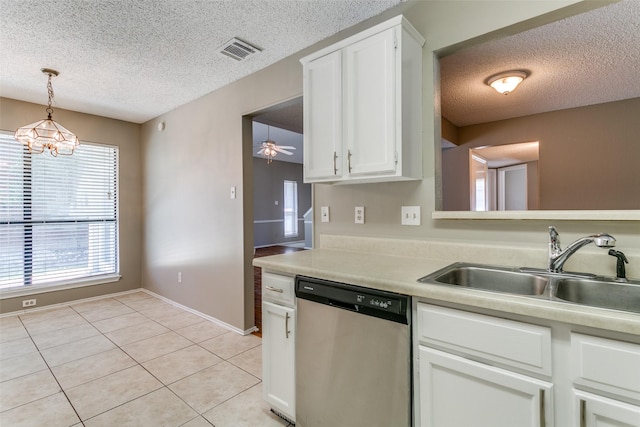 kitchen with visible vents, a sink, white cabinetry, light tile patterned floors, and dishwasher