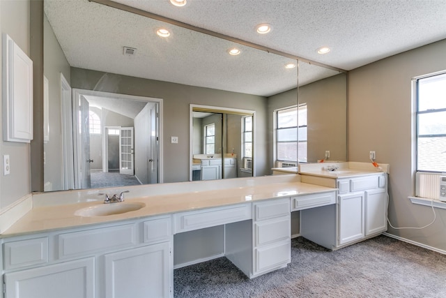 bathroom with recessed lighting, a textured ceiling, vanity, and separate washer and dryer