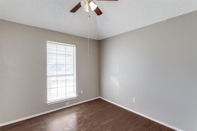 spare room with dark wood finished floors, a textured ceiling, baseboards, and a ceiling fan