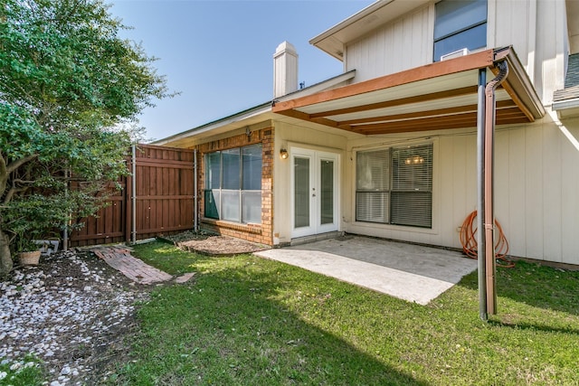 view of yard with a gate, french doors, a patio, and fence