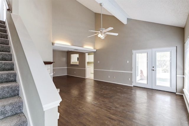 unfurnished living room featuring dark wood finished floors, stairway, beam ceiling, french doors, and a ceiling fan