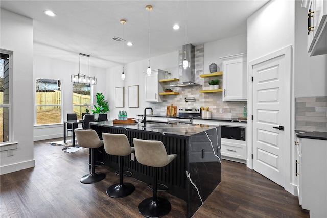 kitchen with open shelves, dark wood-type flooring, wall chimney exhaust hood, dark countertops, and stainless steel range with electric stovetop