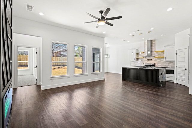 unfurnished living room with dark wood-type flooring, recessed lighting, visible vents, and baseboards