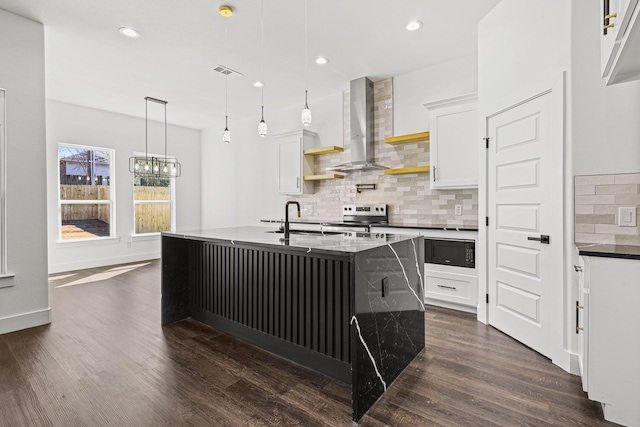 kitchen featuring black microwave, visible vents, wall chimney range hood, stainless steel electric range, and dark wood-style floors