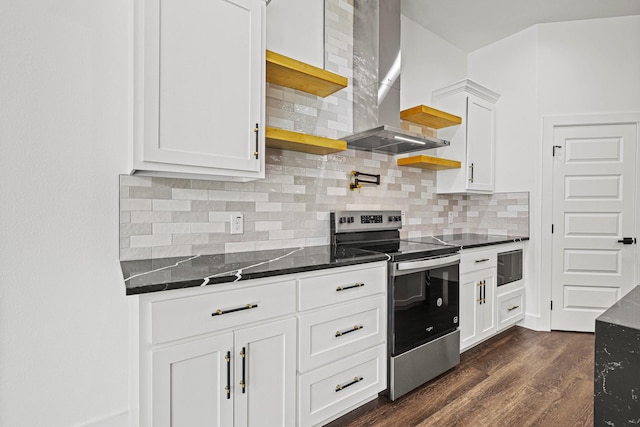 kitchen with white cabinets, electric stove, dark stone countertops, dark wood-style flooring, and wall chimney range hood