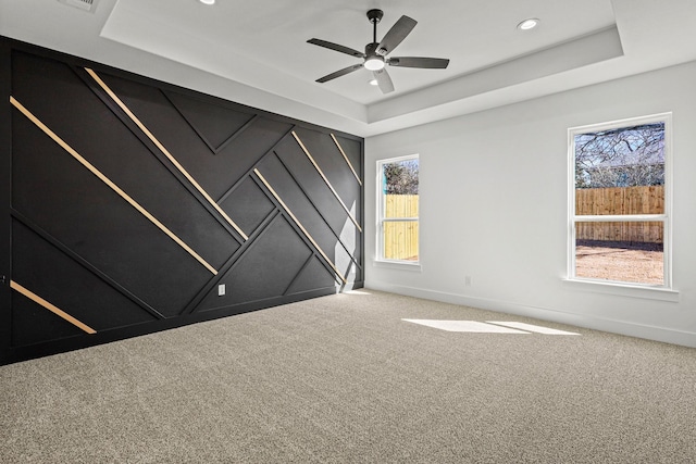 carpeted spare room with baseboards, a tray ceiling, a ceiling fan, and recessed lighting