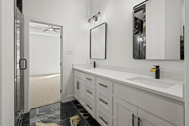 full bathroom with double vanity, marble finish floor, a sink, and a stall shower