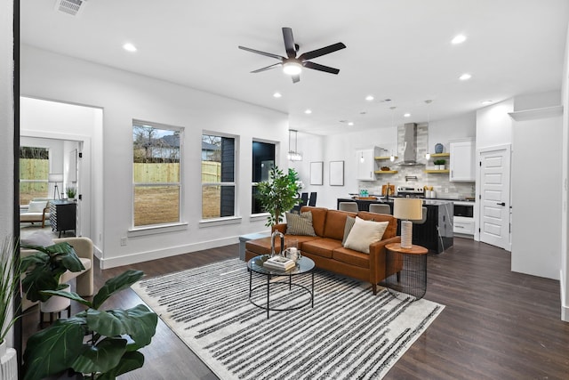 living room featuring dark wood-style floors, visible vents, and recessed lighting