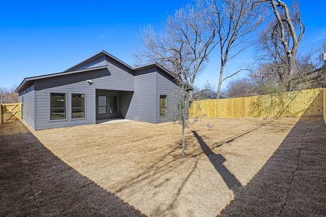 rear view of house with fence