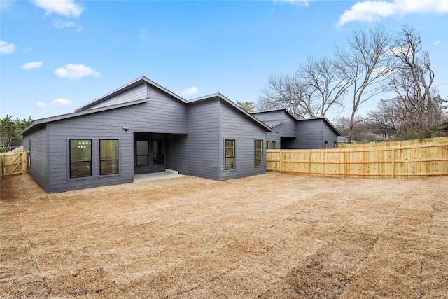 rear view of house featuring fence