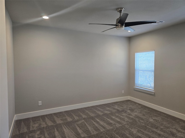 empty room with dark colored carpet, recessed lighting, visible vents, a ceiling fan, and baseboards