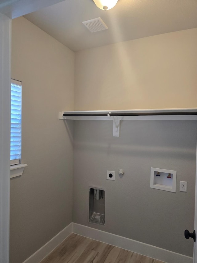 laundry area with visible vents, gas dryer hookup, electric dryer hookup, wood finished floors, and laundry area