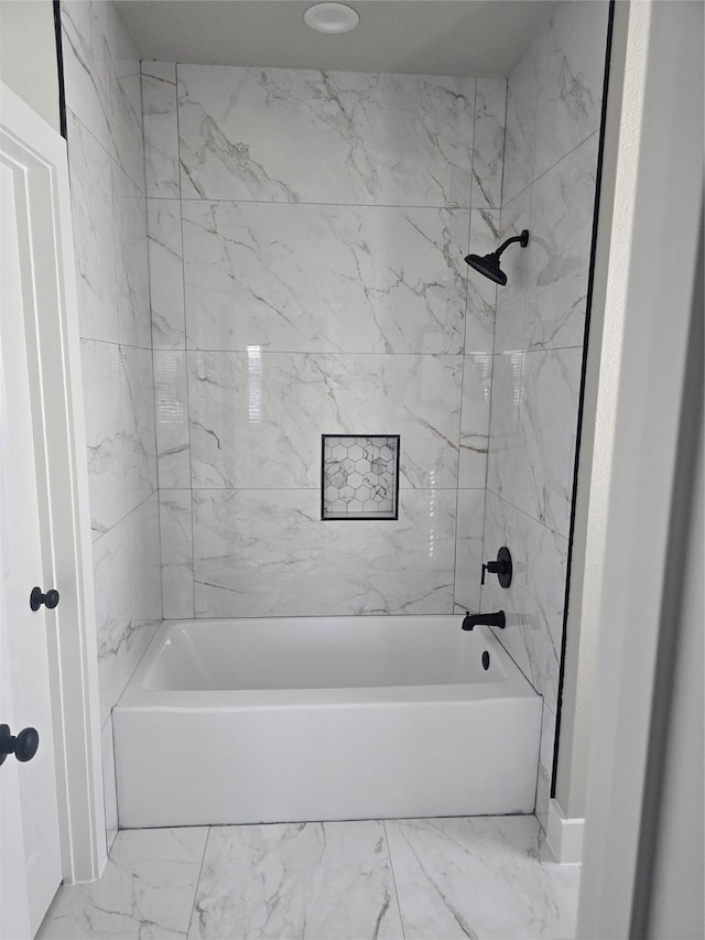 full bathroom with marble finish floor and tub / shower combination