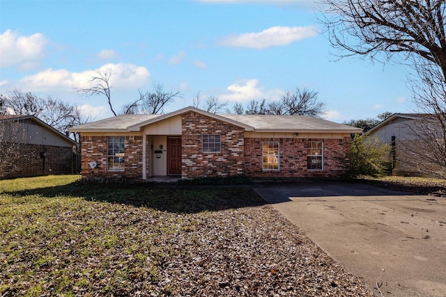 view of front of house featuring brick siding and fence