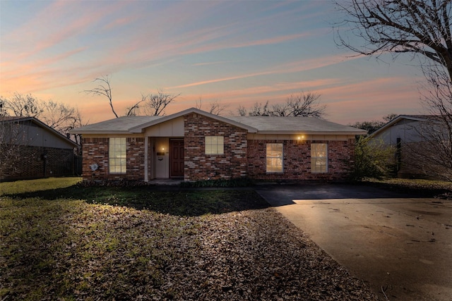 view of front of home with concrete driveway and brick siding