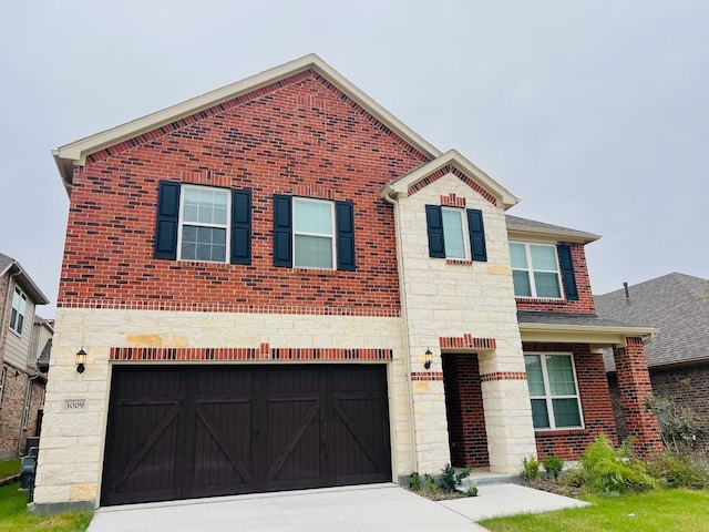 view of front of home featuring an attached garage, brick siding, stone siding, driveway, and roof with shingles