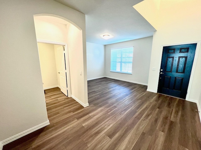 entrance foyer featuring dark wood-style floors and baseboards