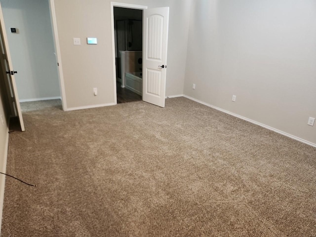 unfurnished bedroom with baseboards and carpet flooring