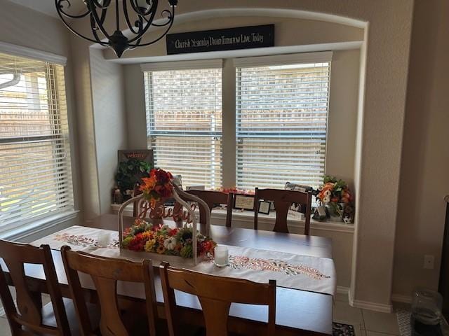 dining space featuring a chandelier and tile patterned floors