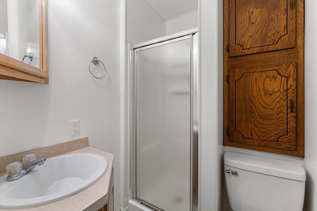 full bath with a sink, toilet, and a stall shower