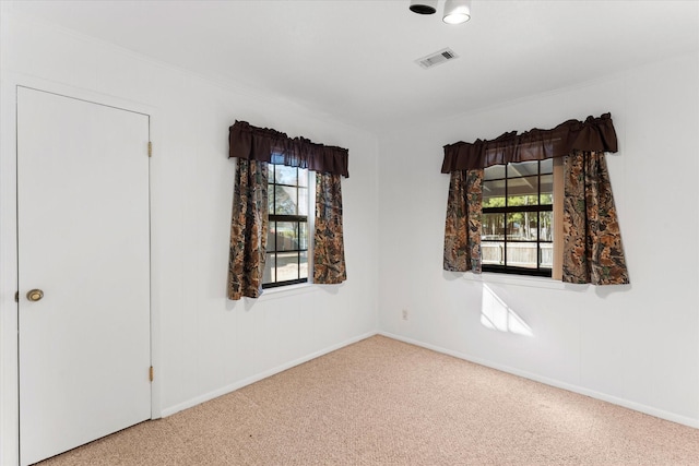 carpeted empty room with baseboards and visible vents