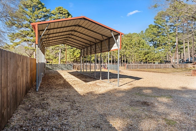 view of home's community featuring a detached carport and fence