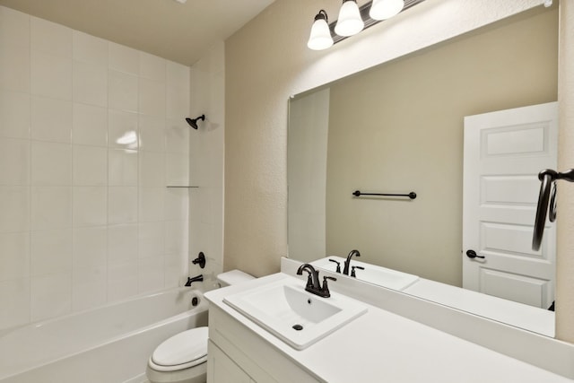 full bath featuring a textured wall, shower / bath combination, vanity, and toilet