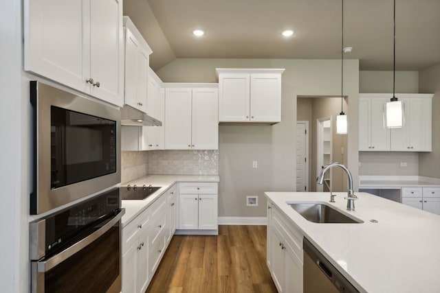 kitchen with pendant lighting, light countertops, black appliances, and white cabinetry