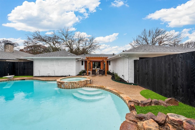 view of pool featuring a patio area, a fenced backyard, a pool with connected hot tub, and a pergola