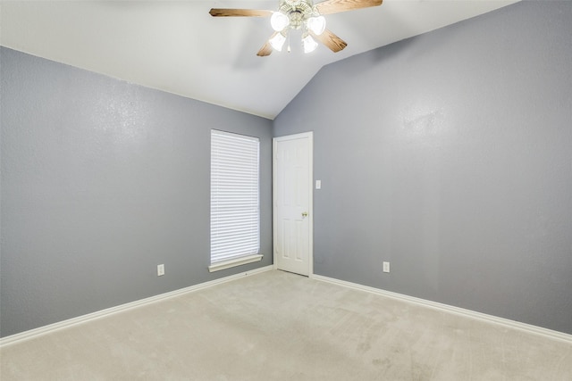 unfurnished room featuring lofted ceiling, ceiling fan, baseboards, and light colored carpet