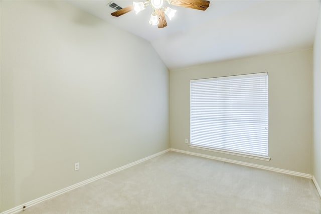 spare room with light carpet, baseboards, visible vents, a ceiling fan, and lofted ceiling