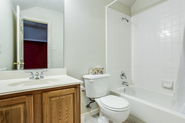 full bathroom featuring  shower combination, a textured wall, vanity, and toilet