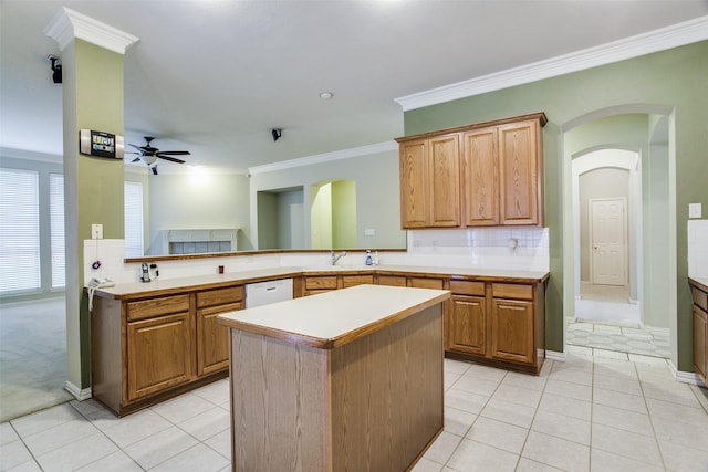 kitchen with light countertops, white dishwasher, a peninsula, and light tile patterned floors