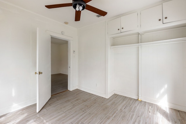 unfurnished bedroom with ceiling fan, baseboards, visible vents, and light wood-style floors