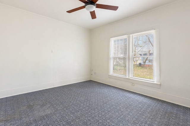 empty room featuring carpet, baseboards, and crown molding