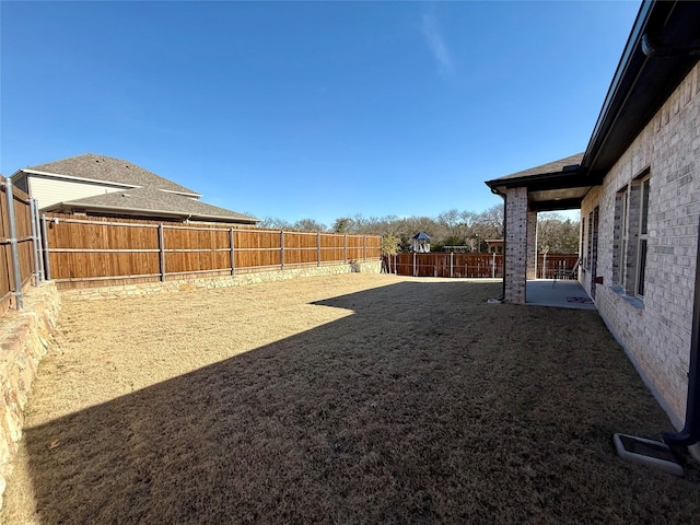 view of yard featuring a fenced backyard and a patio