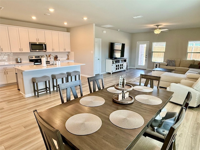 dining area with ceiling fan, light wood-style flooring, recessed lighting, visible vents, and baseboards