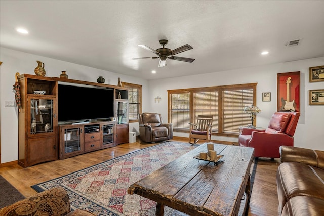 living area with ceiling fan, visible vents, wood finished floors, and recessed lighting