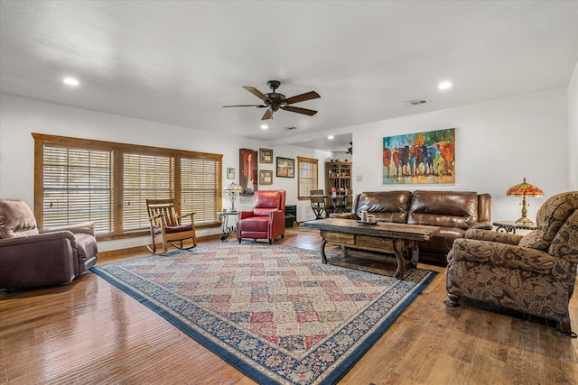 living area with a ceiling fan, visible vents, wood finished floors, and recessed lighting